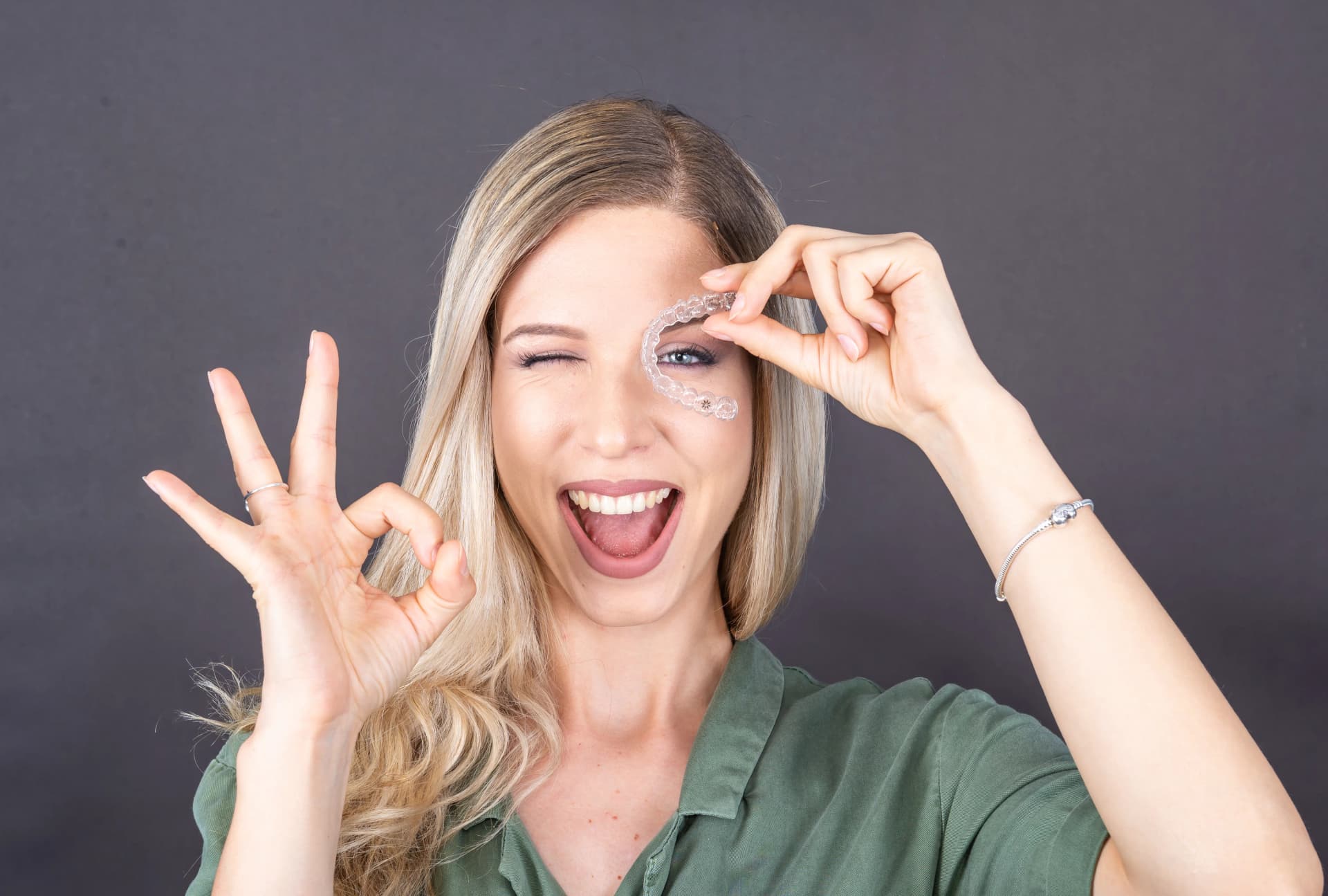 Smiling patient with clear aligners.