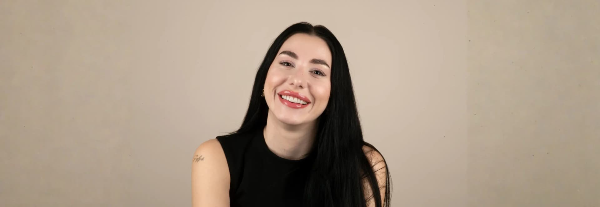 Happy patient showcasing her natural white smile after Aspen dental veneers treatment.