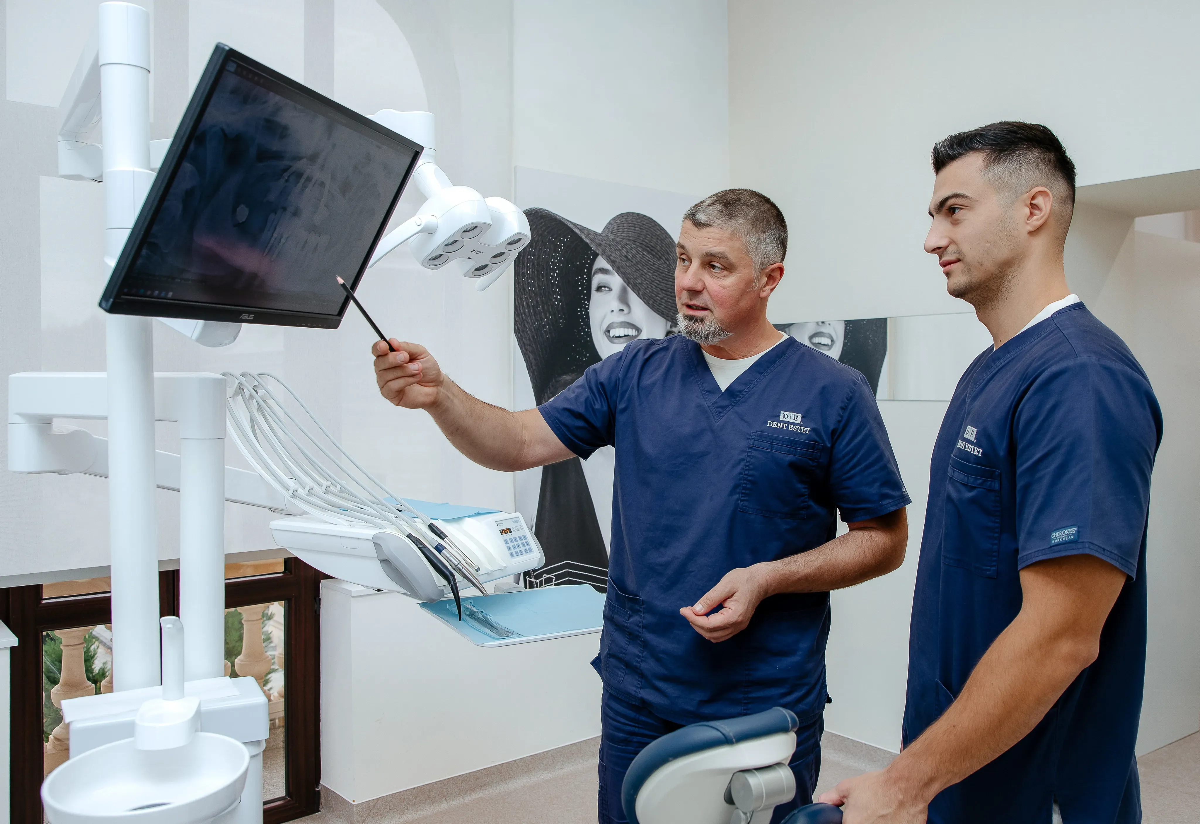 Dr. Alexandru Georgescu and fellow dentist discussing a dental surgery case.